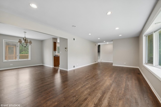 empty room featuring dark wood-style floors, recessed lighting, and baseboards