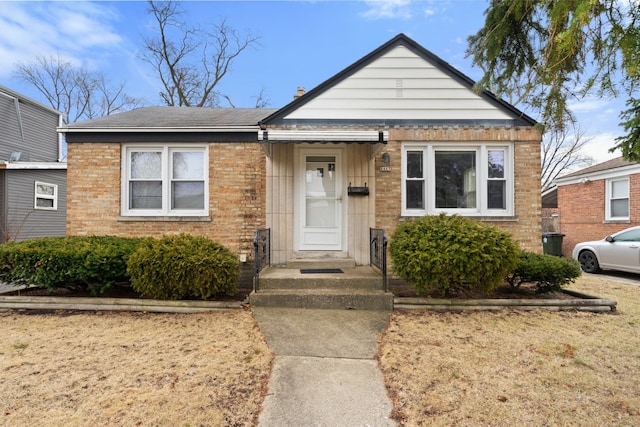 bungalow-style home with brick siding