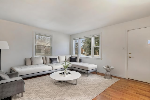 living room featuring light wood finished floors and baseboards