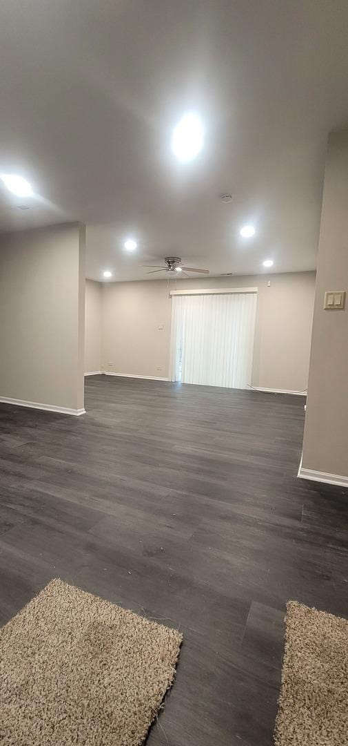 spare room with dark wood-style floors and baseboards