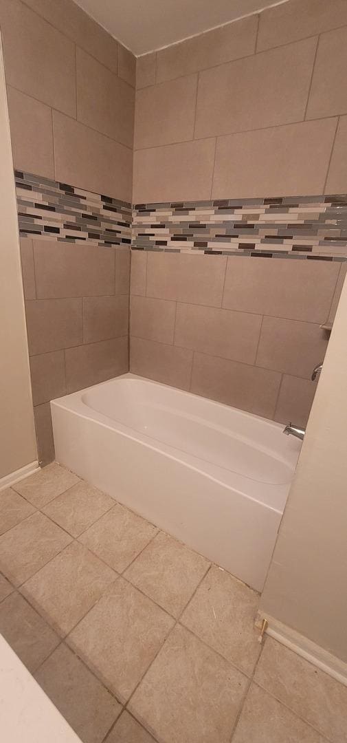 bathroom featuring  shower combination and tile patterned flooring