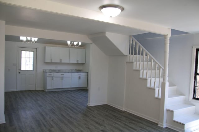 kitchen with baseboards, light countertops, dark wood-style flooring, and a chandelier