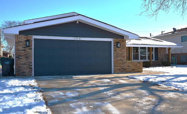 view of front facade with a garage, concrete driveway, and brick siding