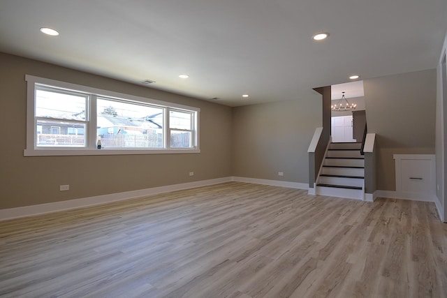 unfurnished living room with recessed lighting, visible vents, stairway, and baseboards