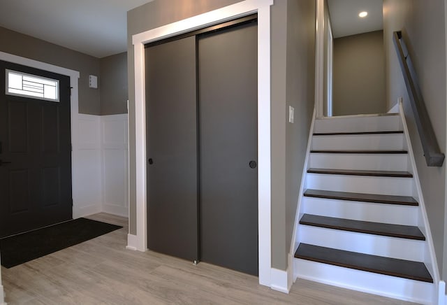 entryway with stairway, recessed lighting, and light wood-style floors