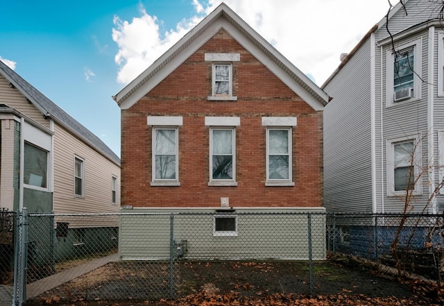 view of side of property featuring brick siding and a fenced backyard