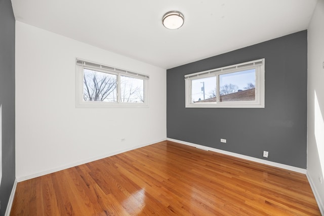 unfurnished bedroom featuring light wood-type flooring and baseboards