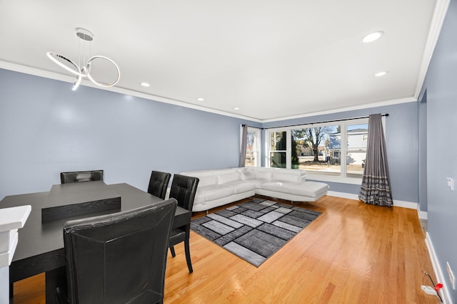 dining room with crown molding, baseboards, and wood finished floors