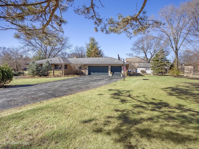 view of front of property with a garage, driveway, and a front lawn