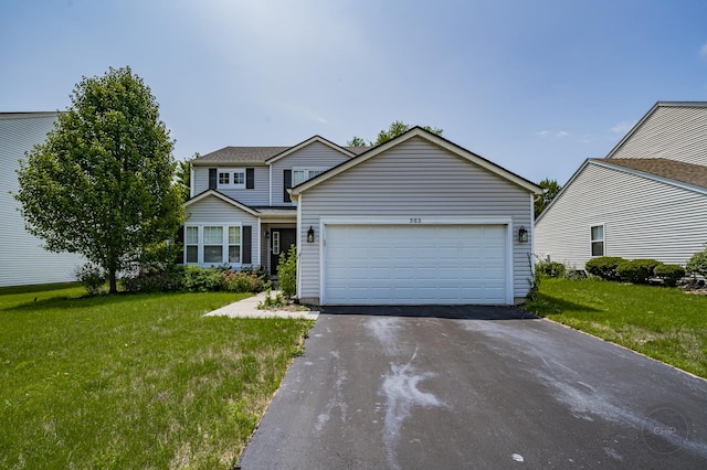 traditional-style home with a front lawn, an attached garage, and aphalt driveway