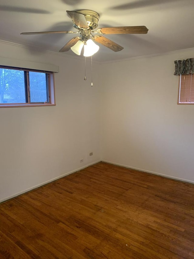 unfurnished room with baseboards, crown molding, a ceiling fan, and wood finished floors