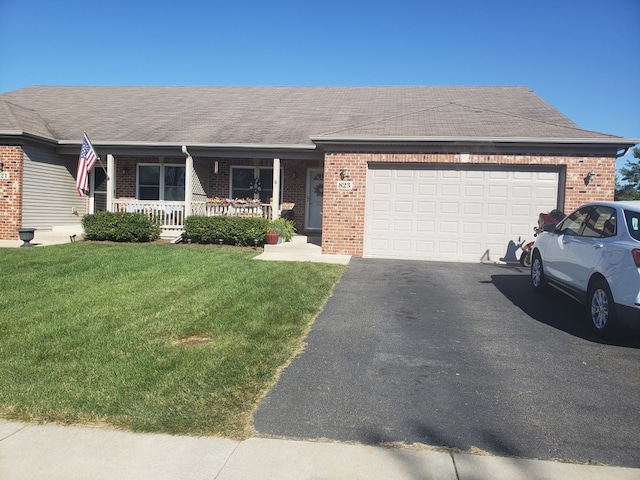 ranch-style house featuring brick siding, a front lawn, aphalt driveway, covered porch, and an attached garage