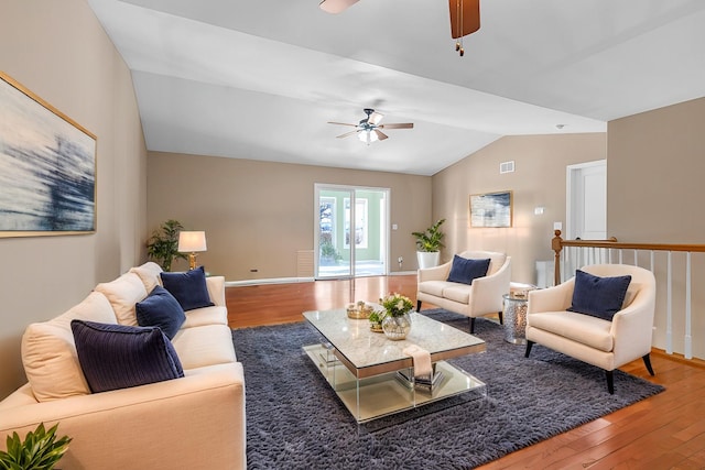 living area featuring baseboards, a ceiling fan, lofted ceiling, and wood finished floors