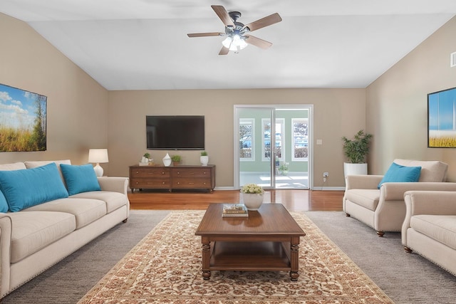 living room featuring ceiling fan, baseboards, lofted ceiling, and wood finished floors