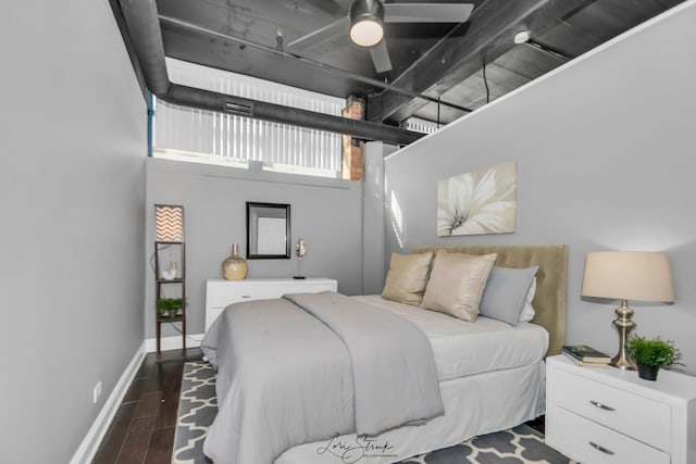 bedroom with wood finished floors and baseboards