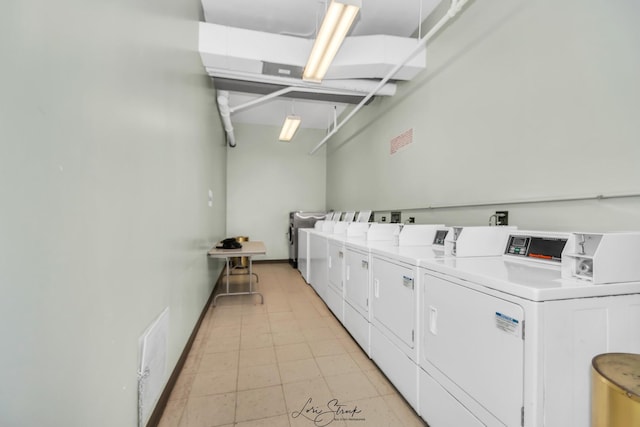 community laundry room with light tile patterned floors and separate washer and dryer