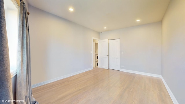 spare room with recessed lighting, light wood-type flooring, and baseboards