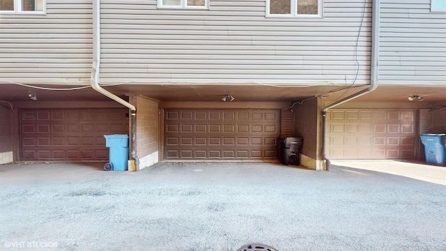 garage featuring aphalt driveway