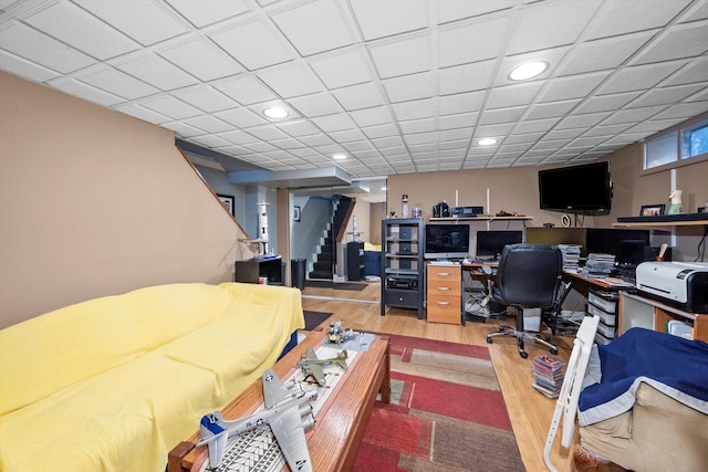 office space featuring recessed lighting, a drop ceiling, and wood finished floors