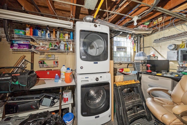 clothes washing area with stacked washer and dryer and laundry area