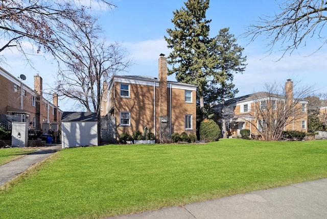 view of front of house with a chimney and a front yard