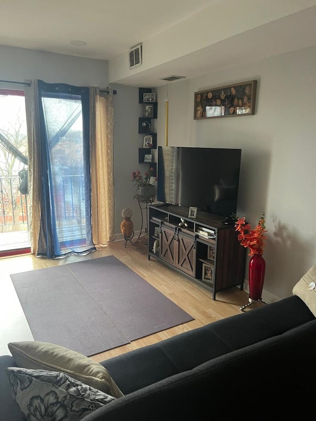 living area with visible vents and light wood-style flooring