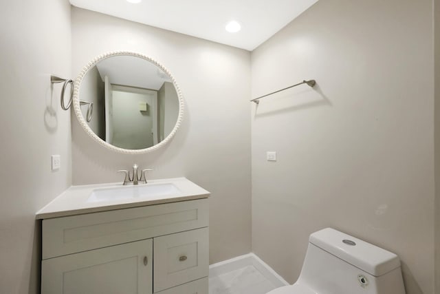 half bath with marble finish floor, baseboards, vanity, and toilet