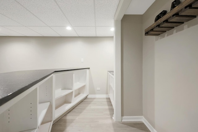 interior space featuring a paneled ceiling and light wood-style flooring