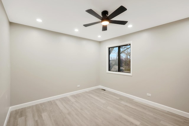 spare room with light wood finished floors and baseboards