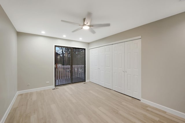 unfurnished bedroom featuring access to outside, baseboards, wood finished floors, and recessed lighting