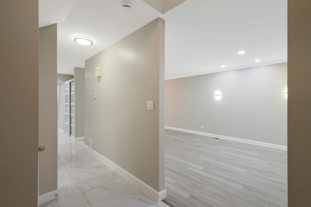 hallway with baseboards and recessed lighting