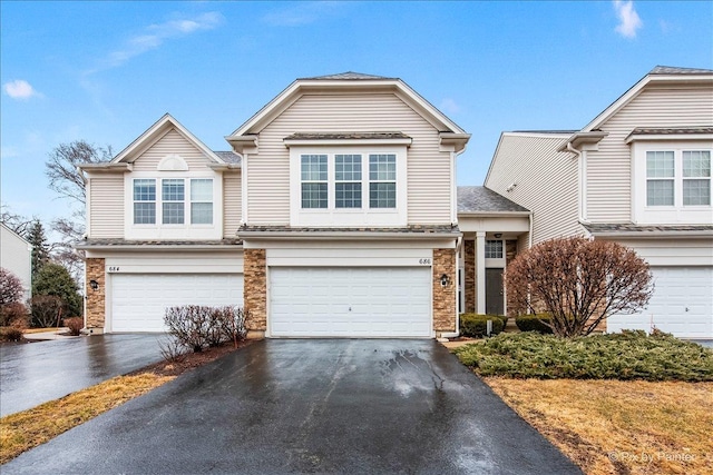 view of front of property with aphalt driveway and an attached garage