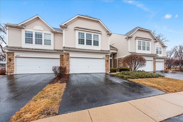 view of front of house with aphalt driveway and an attached garage