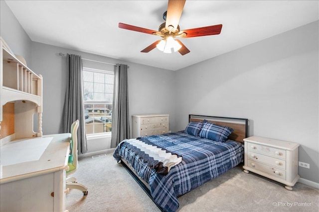 bedroom featuring light carpet, ceiling fan, visible vents, and baseboards