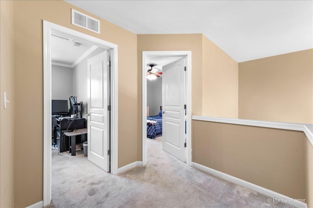 corridor featuring baseboards, visible vents, and carpet flooring