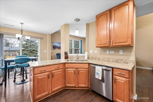 kitchen with a sink, a healthy amount of sunlight, stainless steel dishwasher, and light stone countertops