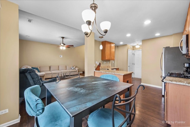 dining room with visible vents, baseboards, dark wood-style flooring, ceiling fan with notable chandelier, and recessed lighting