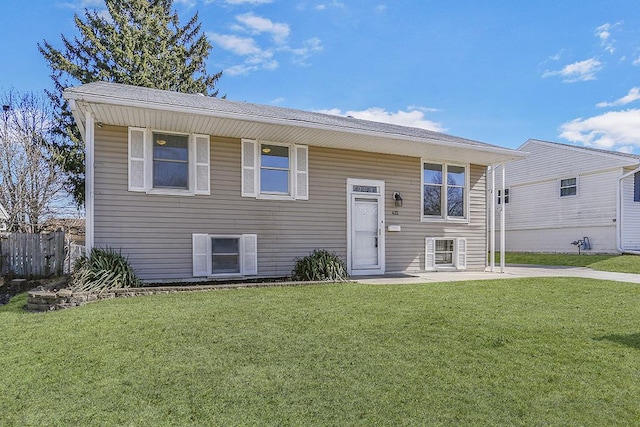 425 Kingston Dr, Romeoville, IL 60446 - bi-level home featuring a front lawn, a patio area, and fence