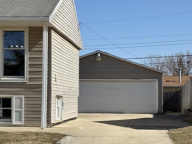 detached garage featuring fence