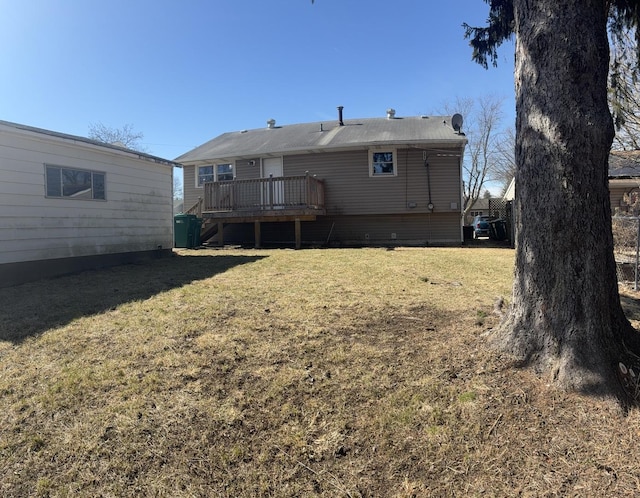 back of house with a lawn and a wooden deck