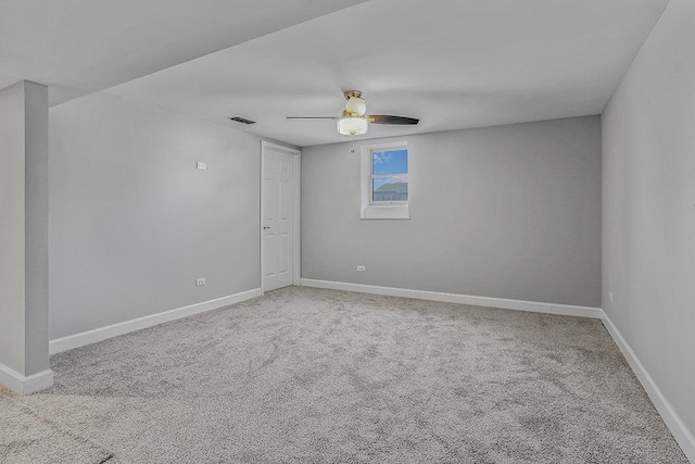 spare room with carpet flooring, baseboards, visible vents, and ceiling fan