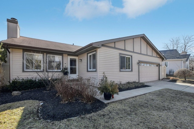 view of front of property with a garage, board and batten siding, concrete driveway, and a chimney