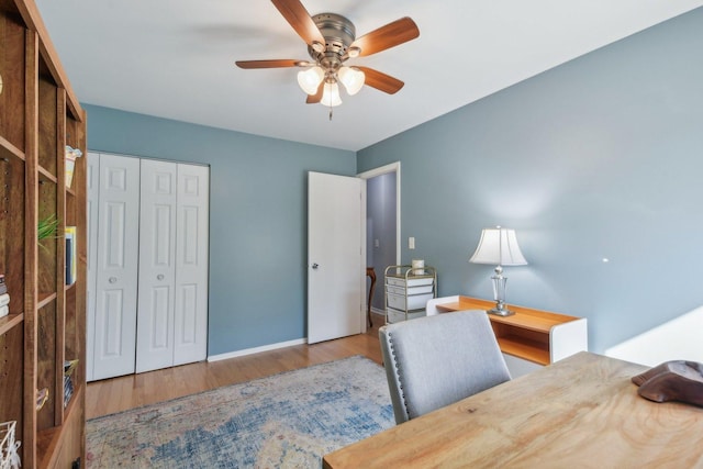 office featuring baseboards, wood finished floors, and ceiling fan