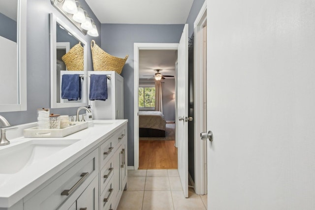 full bathroom with tile patterned flooring, double vanity, connected bathroom, and a sink