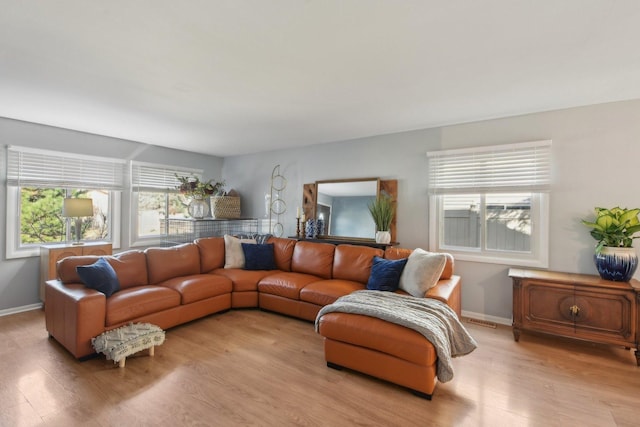 living area with visible vents, baseboards, and light wood-type flooring