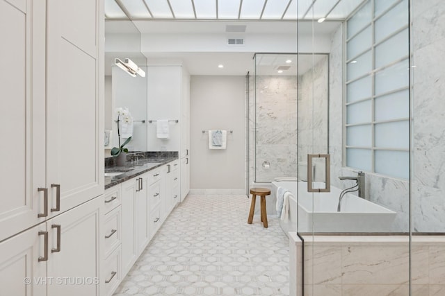 bathroom featuring vanity, a marble finish shower, recessed lighting, a soaking tub, and visible vents