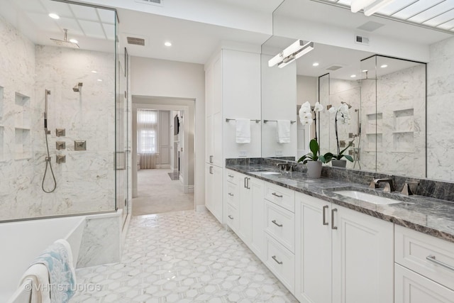 full bathroom featuring double vanity, visible vents, a sink, and a marble finish shower