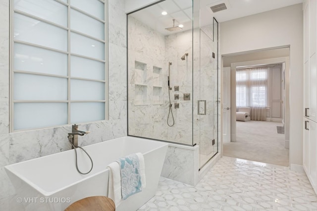 full bath with a freestanding bath, a marble finish shower, and visible vents