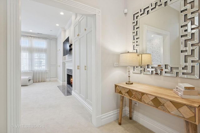 hallway with baseboards, ornamental molding, recessed lighting, and light carpet