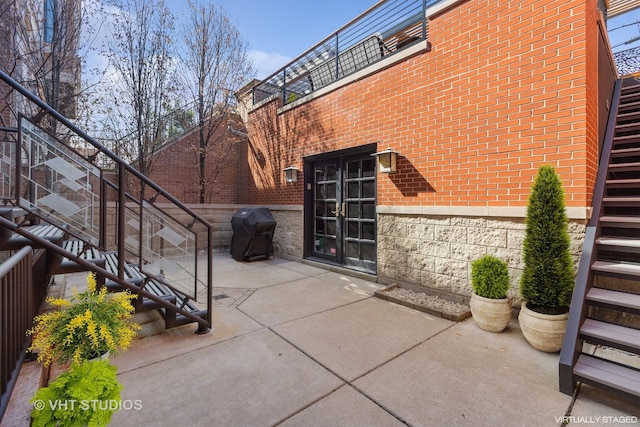 view of patio / terrace with a grill and stairway